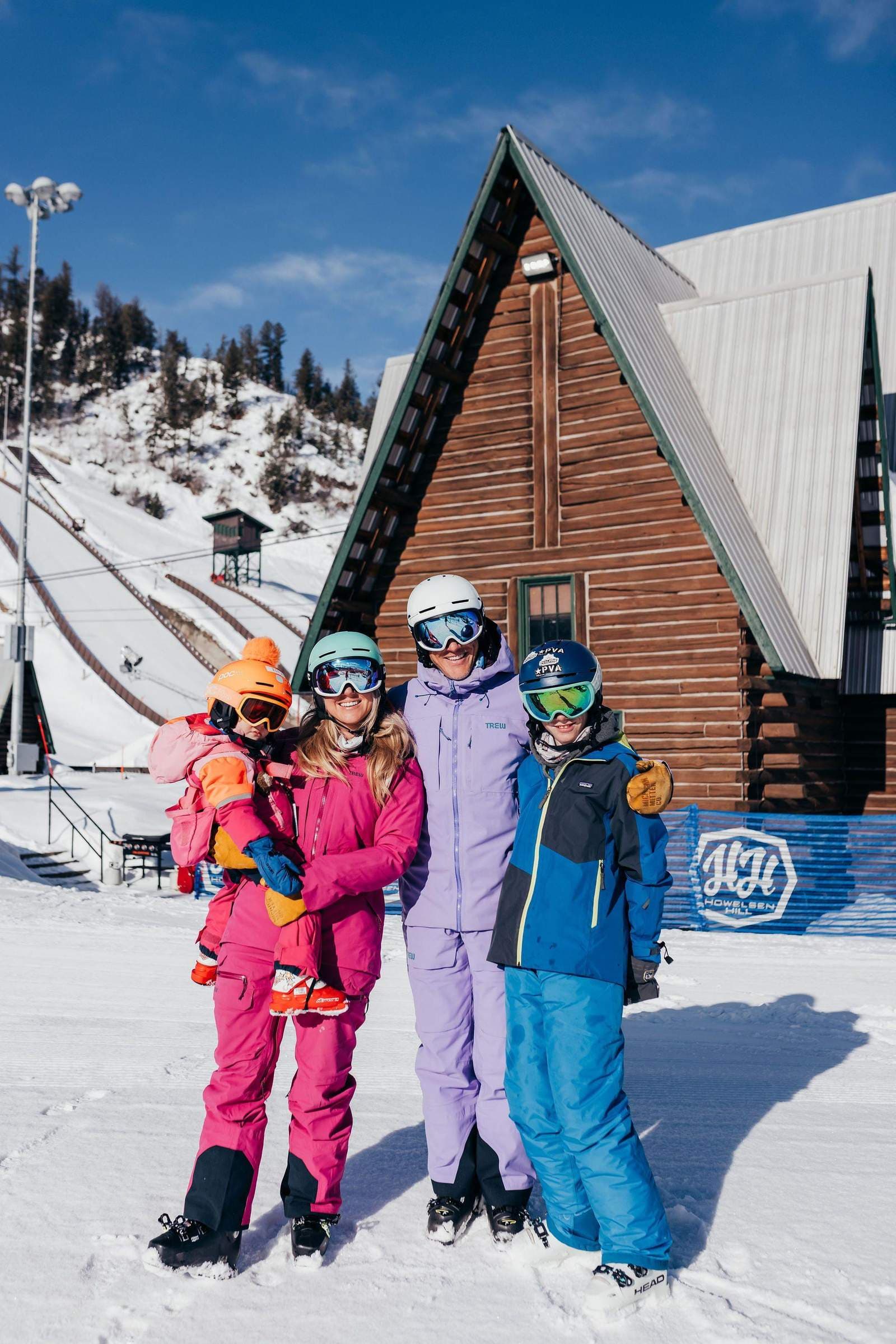The Shorter family at Howelsen Hill with the iconic A-frame lodge and ski jumps