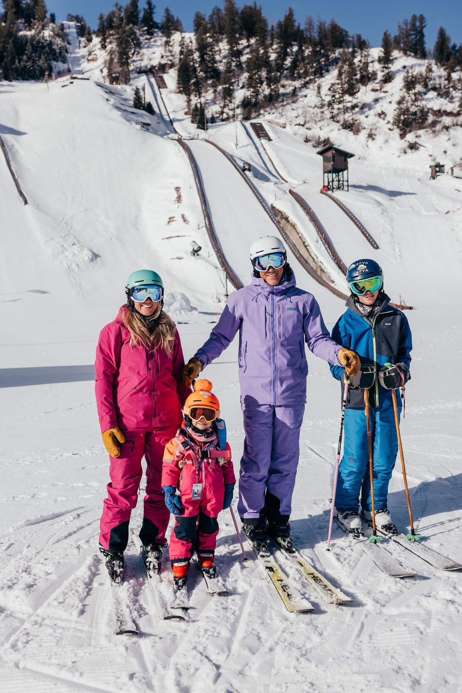 The Shorter family skiing at Howelsen Hill with the ski jumps in the background